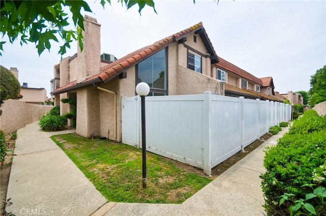 4838 Elrovia Ave Unit E, El Monte, CA 91732 - view of property exterior with stucco siding, a tiled roof, and a chimney