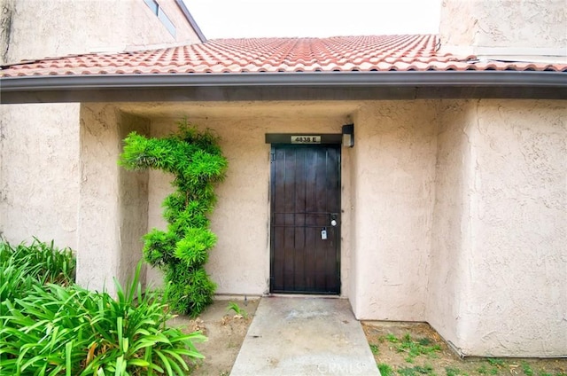4838 Elrovia Ave Unit E, El Monte, CA 91732 - doorway to property with stucco siding and a tiled roof