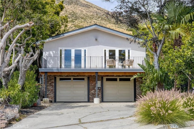 1770 Alrita St, San Luis Obispo, CA 93401 - view of front of house featuring a balcony, a garage, stucco siding, and driveway