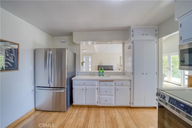 1770 Alrita St, San Luis Obispo, CA 93401 - kitchen featuring appliances with stainless steel finishes, light countertops, white cabinets, and light wood-type flooring