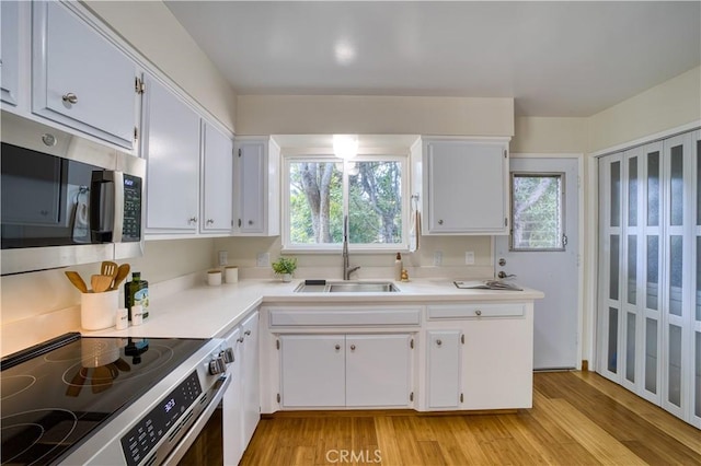 1770 Alrita St, San Luis Obispo, CA 93401 - kitchen featuring appliances with stainless steel finishes, light wood finished floors, and white cabinets