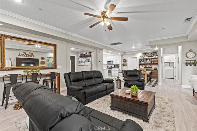 678 Colusa, Gridley, CA 95948 - living room with washer / clothes dryer, a ceiling fan, light wood-type flooring, baseboards, and ornamental molding