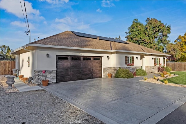 678 Colusa, Gridley, CA 95948 - ranch-style house with stone siding, stucco siding, an attached garage, and solar panels