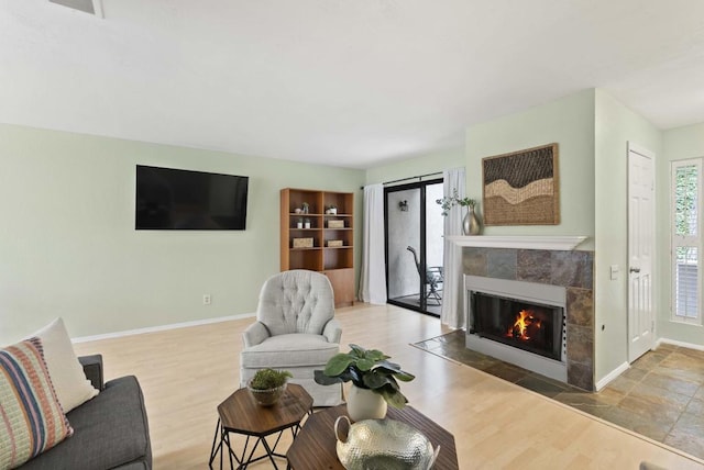 4535 Chateau Dr, San Diego, CA 92117 - living area featuring a tile fireplace, baseboards, and wood finished floors