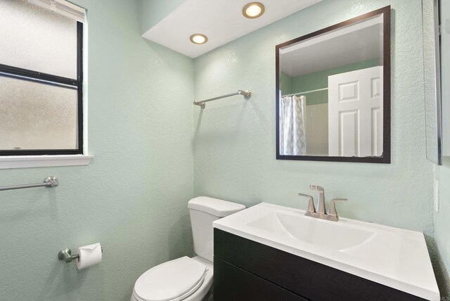 4535 Chateau Dr, San Diego, CA 92117 - full bath with toilet, vanity, a textured wall, and a shower with curtain