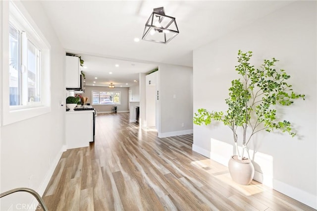 4930 W 142nd St, Hawthorne, CA 90250 - unfurnished living room with light wood-style flooring, recessed lighting, and baseboards