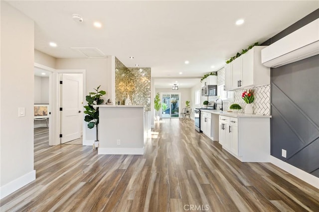 4930 W 142nd St, Hawthorne, CA 90250 - kitchen featuring appliances with stainless steel finishes, wood finished floors, baseboards, white cabinetry, and recessed lighting