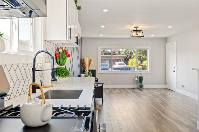 4930 W 142nd St, Hawthorne, CA 90250 - kitchen with exhaust hood, white cabinets, light wood-type flooring, recessed lighting, and a sink