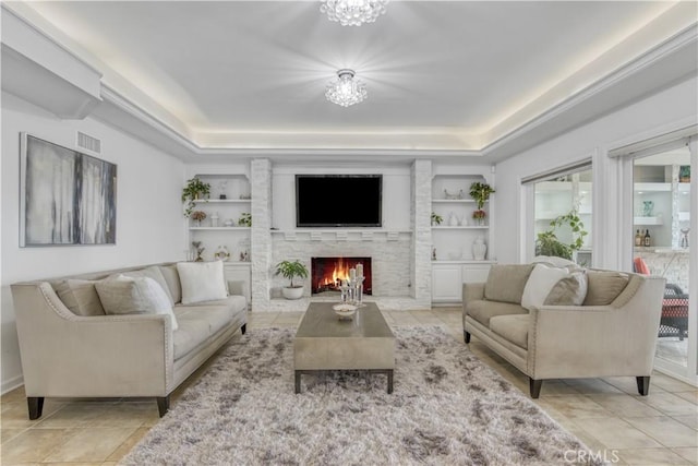 18238 Hastings Way, Porter Ranch, CA 91326 - living area with a tray ceiling, a large fireplace, light tile patterned floors, and a chandelier