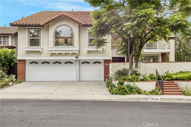 18238 Hastings Way, Porter Ranch, CA 91326 - view of front of property with a garage, concrete driveway, stucco siding, and a tile roof
