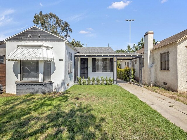 8830 Ruthelen St, Los Angeles, CA 90047 - bungalow with a front yard, a carport, and concrete driveway