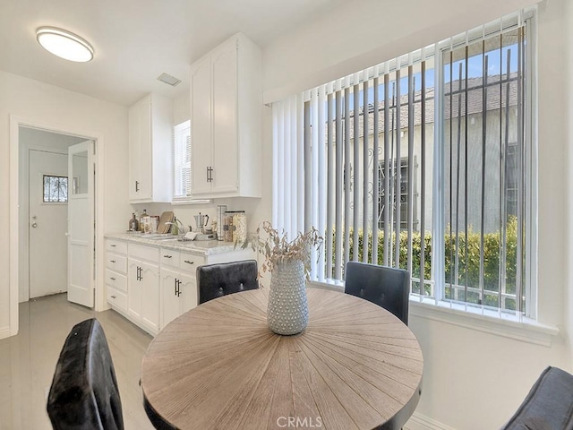 8830 Ruthelen St, Los Angeles, CA 90047 - dining room with baseboards and light wood-style flooring
