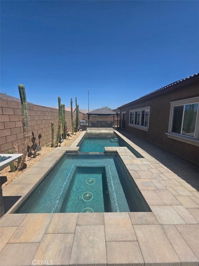 42667 Gazapo Ct, Indio, CA 92203 - view of swimming pool with a gazebo, a fenced backyard, a pool with connected hot tub, and a patio