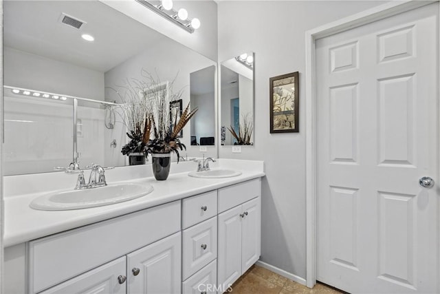 42667 Gazapo Ct, Indio, CA 92203 - bathroom featuring double vanity, a shower, tile patterned floors, and baseboards