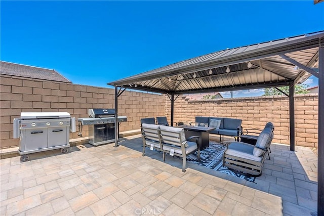 42667 Gazapo Ct, Indio, CA 92203 - fenced backyard featuring a gazebo, outdoor lounge area, a grill, and a patio area