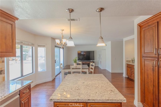 824 Leyland Dr, Diamond Bar, CA 91765 - kitchen with brown cabinetry, wood finished floors, and a chandelier