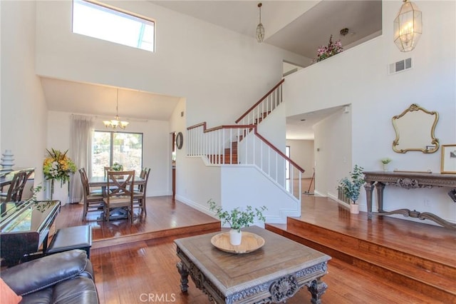 824 Leyland Dr, Diamond Bar, CA 91765 - living area featuring a towering ceiling, plenty of natural light, a chandelier, stairs, and hardwood / wood-style flooring