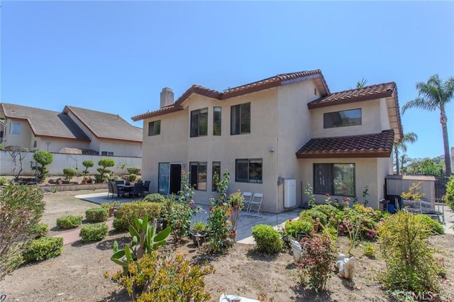 824 Leyland Dr, Diamond Bar, CA 91765 - back of house featuring a tiled roof, a patio area, a chimney, and stucco siding