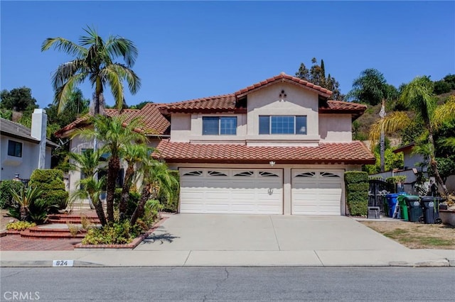 824 Leyland Dr, Diamond Bar, CA 91765 - mediterranean / spanish-style house featuring a tile roof, an attached garage, concrete driveway, and stucco siding