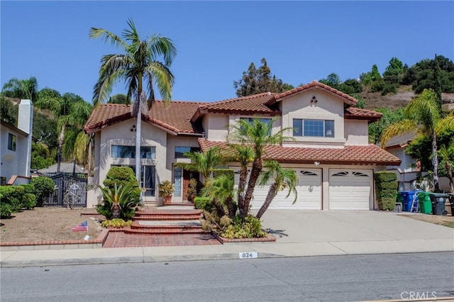 824 Leyland Dr, Diamond Bar, CA 91765 - mediterranean / spanish home with stucco siding, concrete driveway, an attached garage, a tiled roof, and a gate