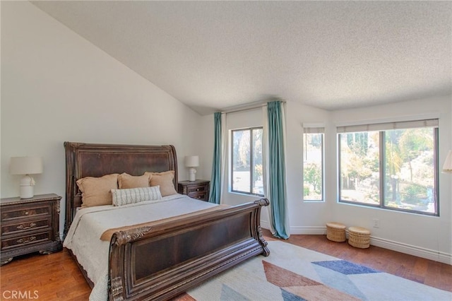 824 Leyland Dr, Diamond Bar, CA 91765 - bedroom featuring wood finished floors, vaulted ceiling, and a textured ceiling