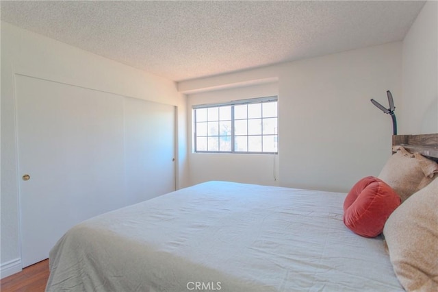 824 Leyland Dr, Diamond Bar, CA 91765 - bedroom featuring wood finished floors, a textured ceiling, and a closet