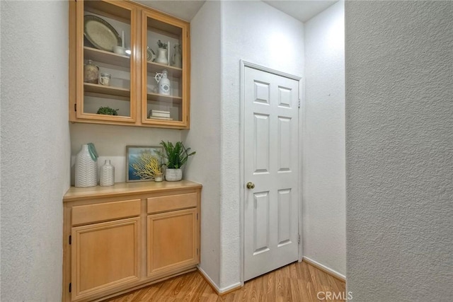 143 Brisas St, Oceanside, CA 92058 - hall with light wood finished floors, a textured wall, and baseboards