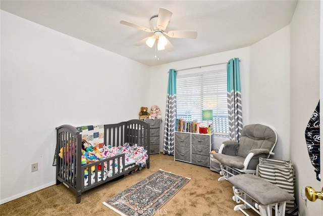143 Brisas St, Oceanside, CA 92058 - carpeted bedroom with a crib, a ceiling fan, and baseboards