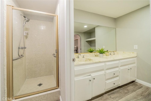17470 Krameria Ave, Riverside, CA 92504 - bathroom with a shower stall, wood finished floors, and double vanity