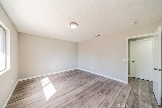 17470 Krameria Ave, Riverside, CA 92504 - unfurnished room featuring light wood-type flooring, a textured ceiling, and a smoke detector