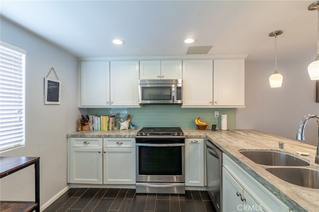 4357 W Sarah St Unit 26, Burbank, CA 91505 - kitchen with stainless steel appliances, a sink, tasteful backsplash, white cabinetry, and dark wood-style floors