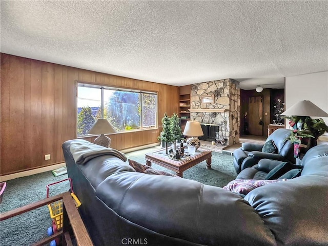 113 Fremont Rd, Lake Arrowhead, CA 92352 - living room with carpet flooring, wooden walls, a textured ceiling, a fireplace, and baseboard heating