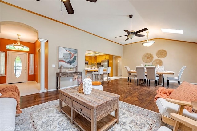 625 Redwing Dr, Merced, CA 95340 - living area featuring ceiling fan, decorative columns, wood finished floors, arched walkways, and crown molding