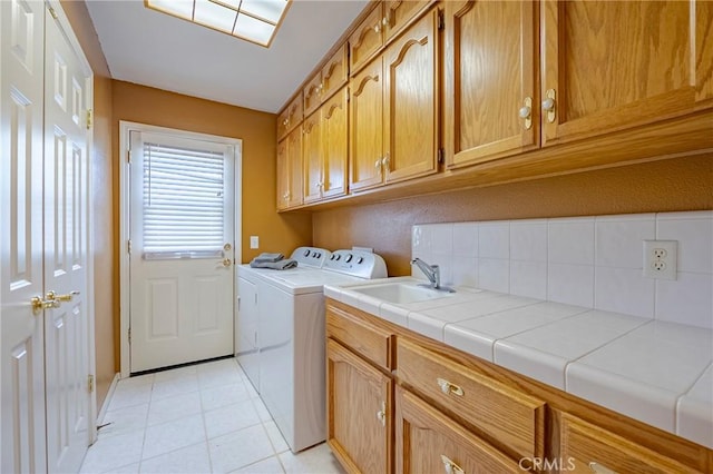 625 Redwing Dr, Merced, CA 95340 - laundry area with cabinet space, washer and clothes dryer, and light tile patterned floors