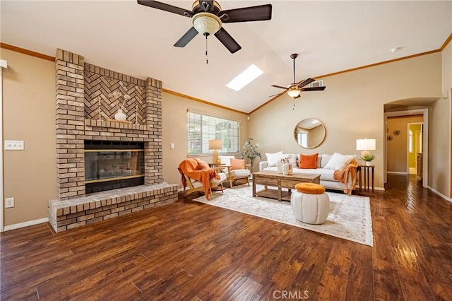 625 Redwing Dr, Merced, CA 95340 - living area featuring a ceiling fan, ornamental molding, a brick fireplace, wood finished floors, and baseboards