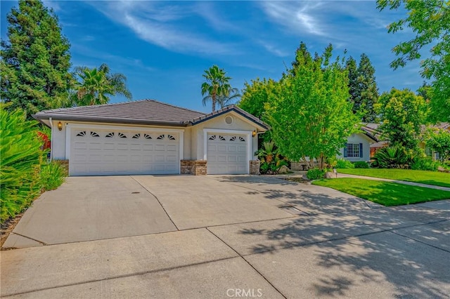 625 Redwing Dr, Merced, CA 95340 - view of front facade featuring concrete driveway, a garage, a tile roof, and stucco siding