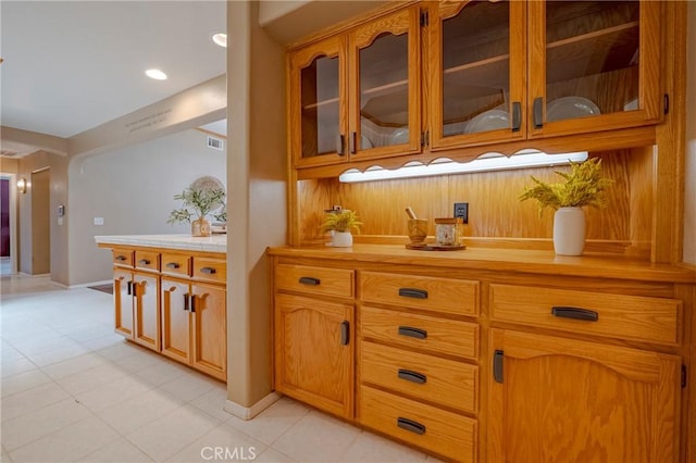 625 Redwing Dr, Merced, CA 95340 - kitchen featuring light countertops, glass insert cabinets, light tile patterned flooring, baseboards, and recessed lighting