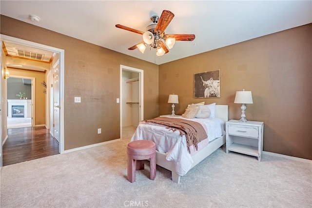 625 Redwing Dr, Merced, CA 95340 - carpeted bedroom with baseboards, a walk in closet, and a ceiling fan