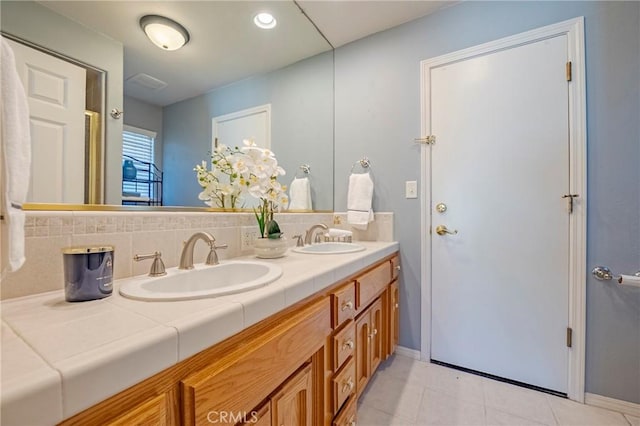 625 Redwing Dr, Merced, CA 95340 - bathroom featuring double vanity, tasteful backsplash, baseboards, and tile patterned floors