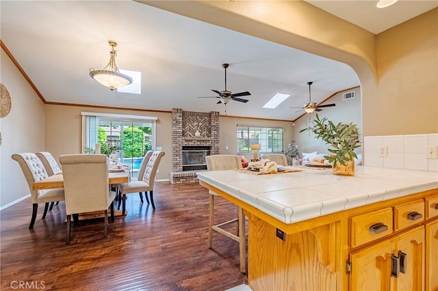 625 Redwing Dr, Merced, CA 95340 - kitchen featuring a ceiling fan, plenty of natural light, tile countertops, lofted ceiling, and crown molding