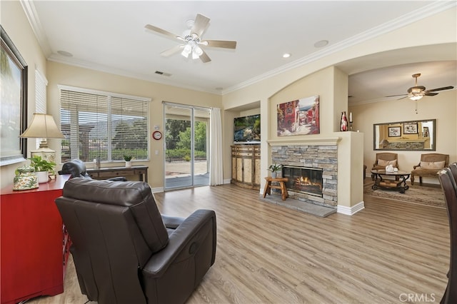 23463 Canterbury Way, Murrieta, CA 92562 - living area featuring ceiling fan, light wood-type flooring, a stone fireplace, crown molding, and baseboards