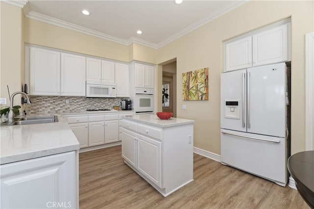 23463 Canterbury Way, Murrieta, CA 92562 - kitchen featuring white appliances, a sink, crown molding, light wood-style flooring, and white cabinetry