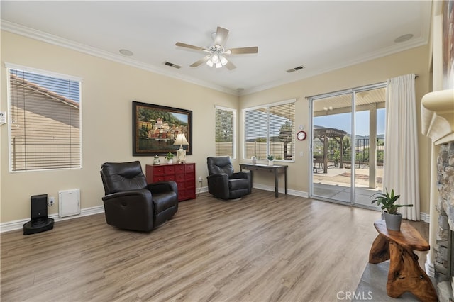 23463 Canterbury Way, Murrieta, CA 92562 - living area featuring light wood-style floors, a ceiling fan, crown molding, baseboards, and a stone fireplace