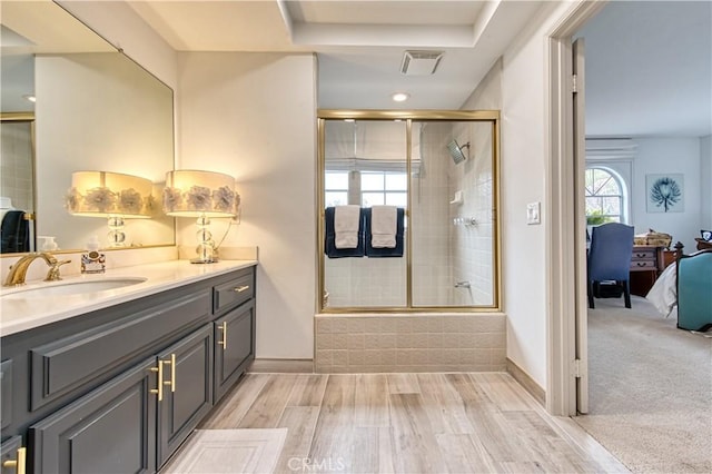 25536 Rue Terrase Unit 17, Laguna Niguel, CA 92677 - ensuite bathroom featuring vanity, bath / shower combo with glass door, and wood finished floors