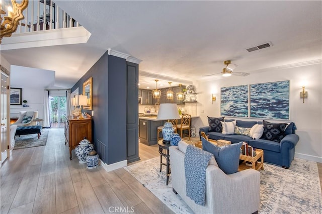 25536 Rue Terrase Unit 17, Laguna Niguel, CA 92677 - living room with light wood finished floors, a ceiling fan, and a chandelier