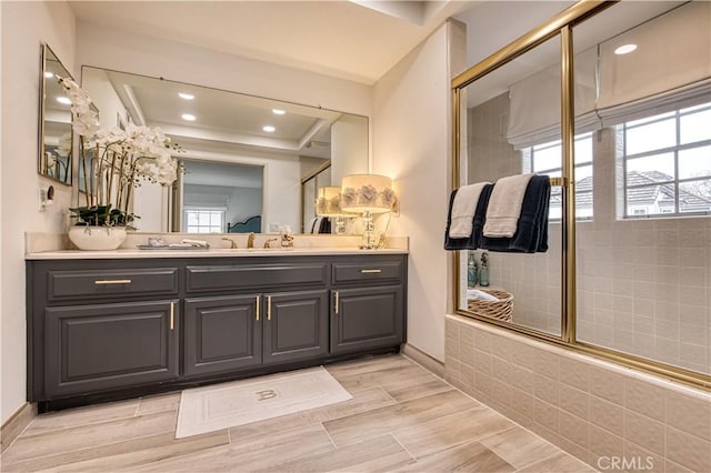 25536 Rue Terrase Unit 17, Laguna Niguel, CA 92677 - bathroom featuring double vanity, a tile shower, recessed lighting, and wood finished floors