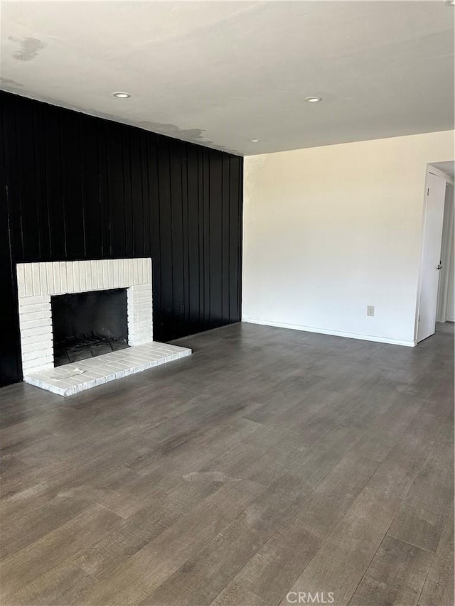 45208 17th St W, Lancaster, CA 93534 - unfurnished living room with a fireplace, wood finished floors, wooden walls, baseboards, and recessed lighting