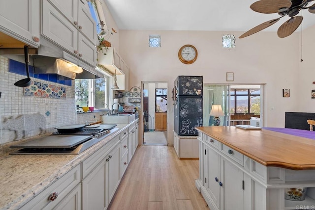 2620 Mar Vinga, Fallbrook, CA 92028 - kitchen featuring light wood finished floors, backsplash, stovetop, a ceiling fan, and white cabinets