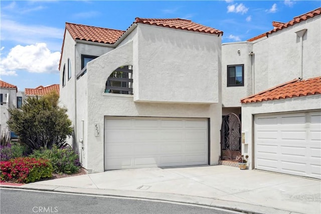 4219 Andros Cir, Huntington Beach, CA 92649 - mediterranean / spanish-style house featuring a tile roof, an attached garage, stucco siding, and driveway
