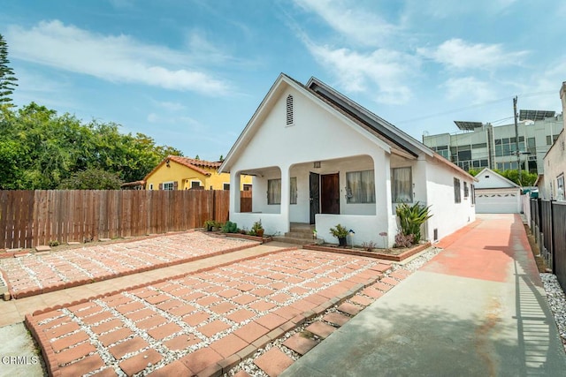 3247 La Clede Ave, Los Angeles, CA 90039 - view of front of property with stucco siding, a garage, covered porch, and an outdoor structure